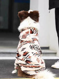 Rear view of a dog in a cream-colored fleece jacket with a geometric pattern.