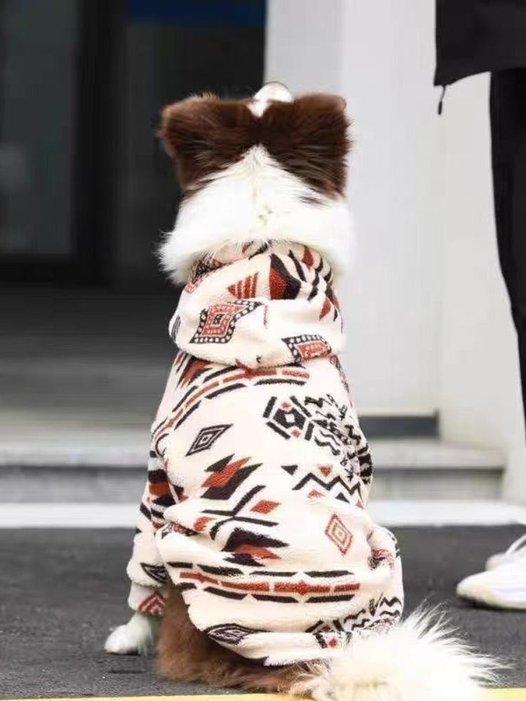 Rear view of a dog in a cream-colored fleece jacket with a geometric pattern.