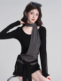 Close-up of the grey fabric overlay and scarf detail on the black top