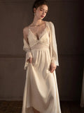 Close-up of the lace detailing on the V-neck slip dress.