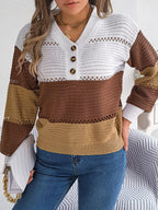 Front view of a woman in a color block knit sweater with a V-neck, button placket, and long sleeves.