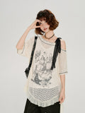 Close-up of the graphic print on the cream lace tunic.