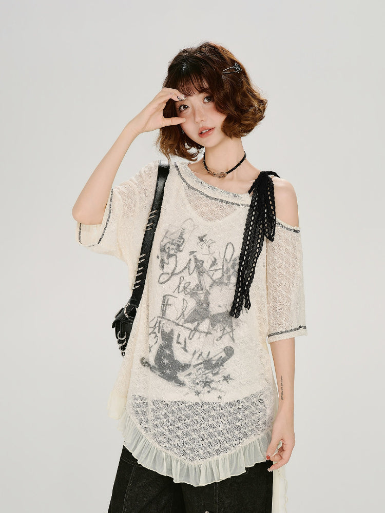 Close-up of the graphic print on the cream lace tunic.