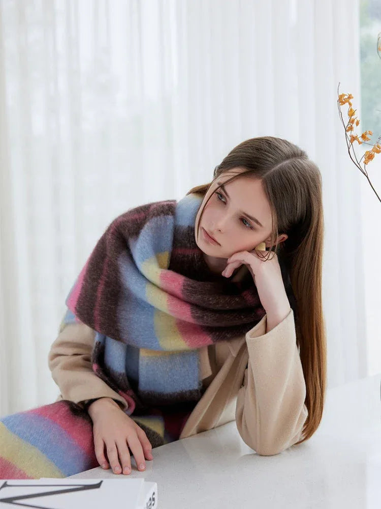 woman wearing a pink, blue, yellow, and brown striped oversized shawl scarf