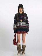 Woman wearing a navy blue knit sweater with a Fair Isle pattern featuring reindeer and snowflake motifs, paired with a red mini skirt and beige boots.
