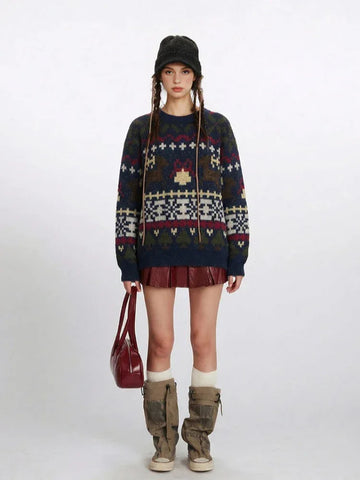 Woman wearing a navy blue knit sweater with a Fair Isle pattern featuring reindeer and snowflake motifs, paired with a red mini skirt and beige boots.