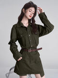 Close-up of a woman in a green collared dress, showcasing the fabric and button details.
