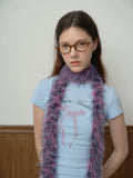 Front view of a woman in a light blue t-shirt and white skirt, accessorized with a statement faux fur scarf.