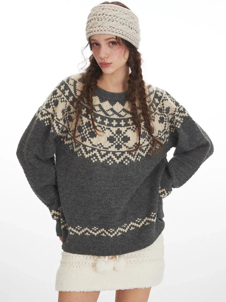 Fashion shot of a woman in a grey Fair Isle crewneck sweater