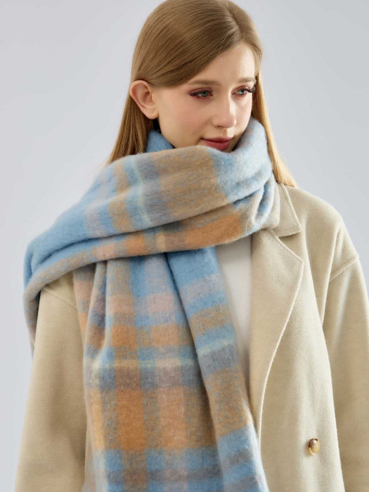 close-up of a woman wearing a blue and tan plaid scarf