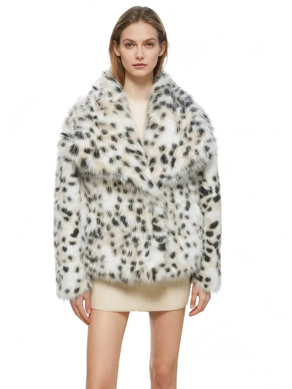 Woman wearing a black and white faux fur leopard print cropped jacket with a wide lapel