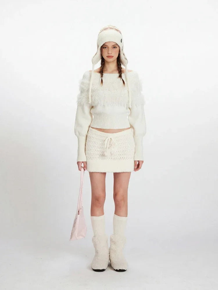 Woman wearing a white off-the-shoulder knit sweater with fuzzy trim and a matching white knit mini skirt with a drawstring waist. Main image