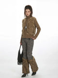 A woman showcases a unique winter-inspired outfit with statement accessories.