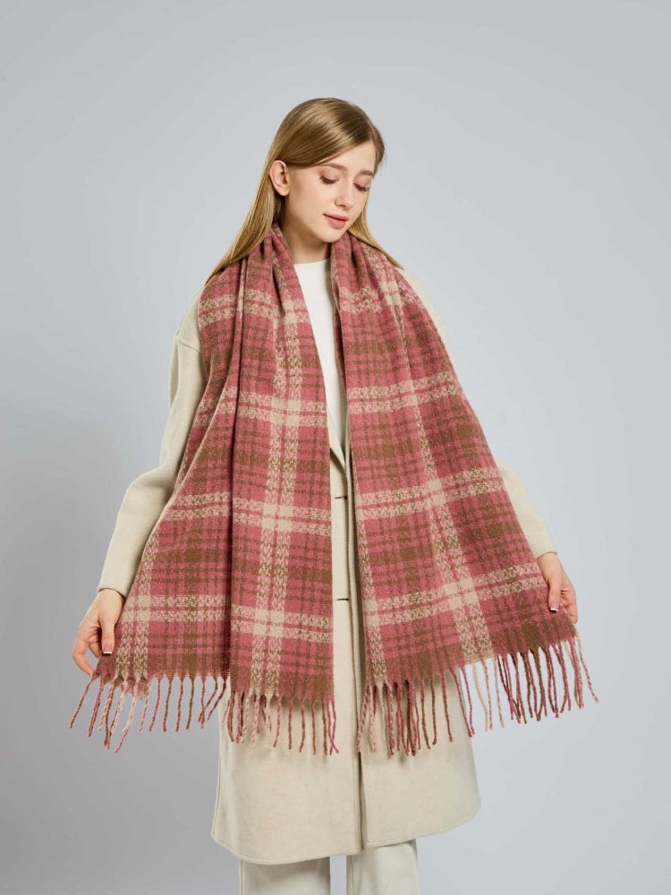 Close-up of a woman's face with a plaid scarf draped around her neck.