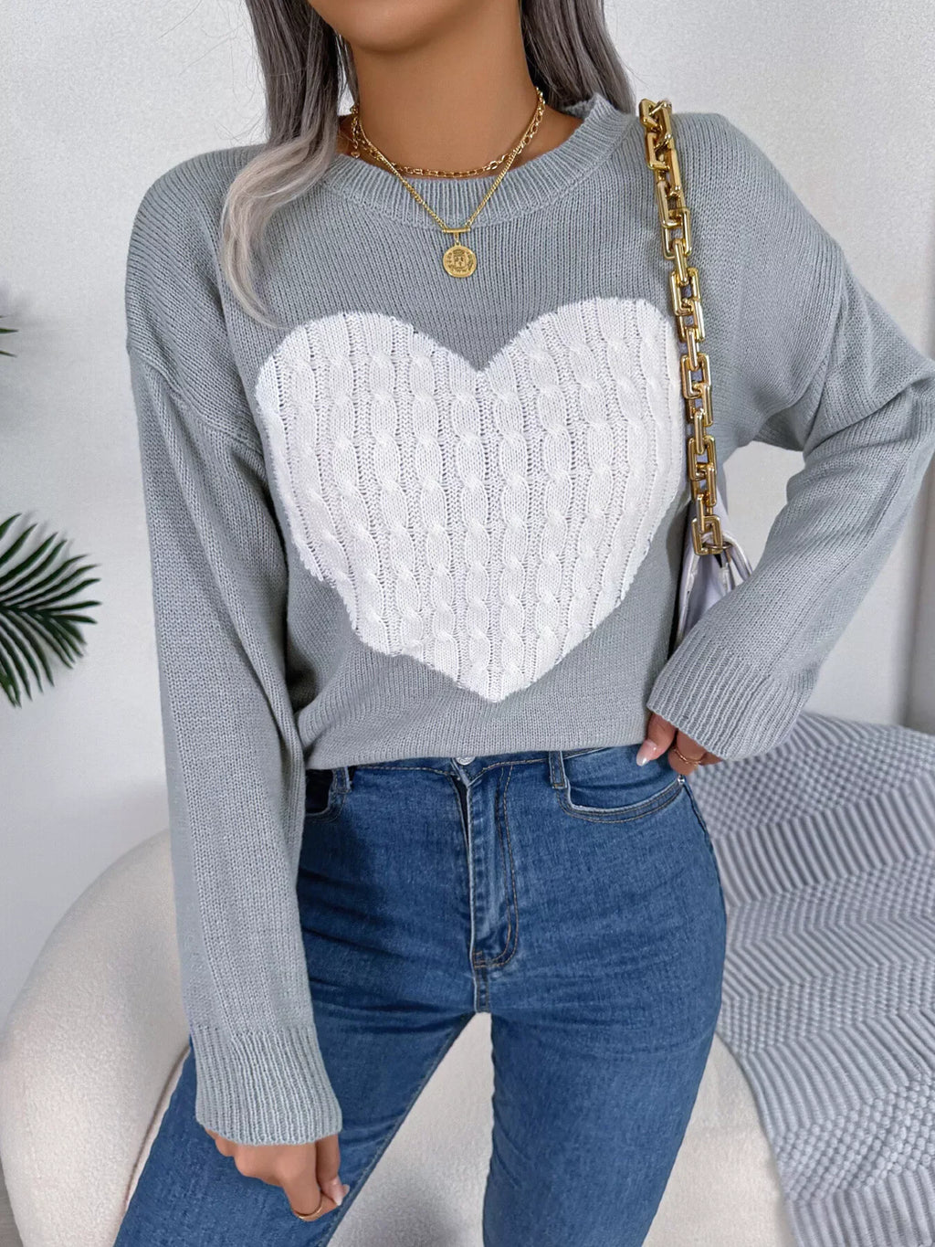 Close-up of the heart graphic on the grey sweater.