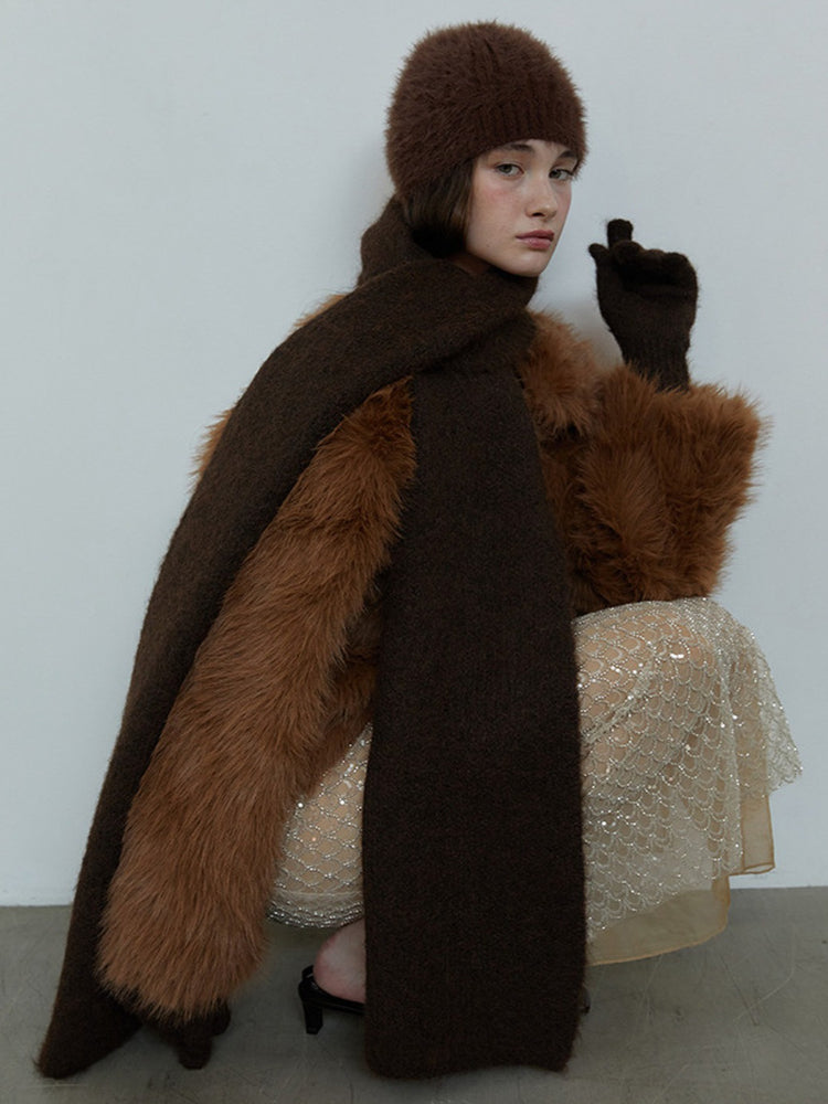 Model wearing a brown knit scarf and matching beanie