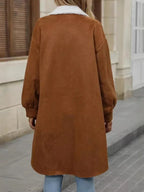 Back view of a woman wearing a long brown fleece shirt jacket.