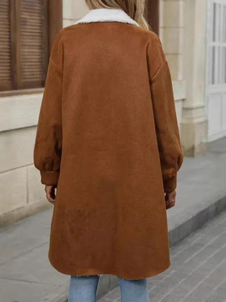 Back view of a woman wearing a long brown fleece shirt jacket.
