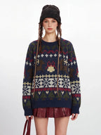 Front view of a woman in a navy blue knit sweater with a Fair Isle pattern, red mini skirt, and black beanie.