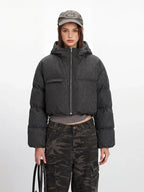 Close-up of the grey textured fabric of the cropped puffer jacket.