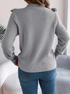 Back view of a woman in a gray textured knit sweater