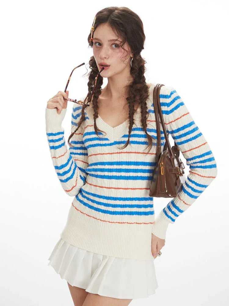 Close-up of a woman wearing a blue and white striped knit sweater.
