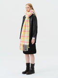woman wearing pink and yellow plaid oversized wool blend scarf