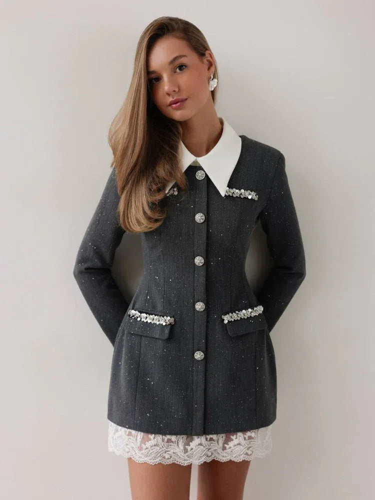 Woman wearing a grey tweed-inspired mini dress with a white collar and crystal buttons