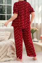 Back view of a woman in a red printed pajama set.