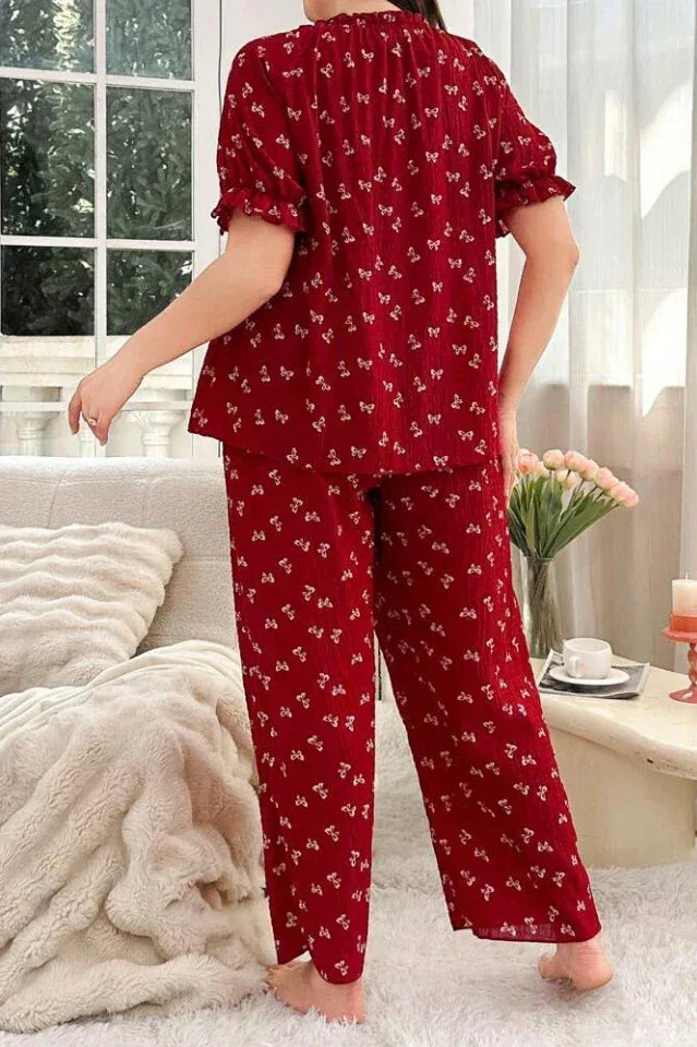 Back view of a woman in a red printed pajama set.
