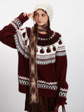 Front detail of a woman's Fair Isle sweater featuring an apple pattern and geometric yoke