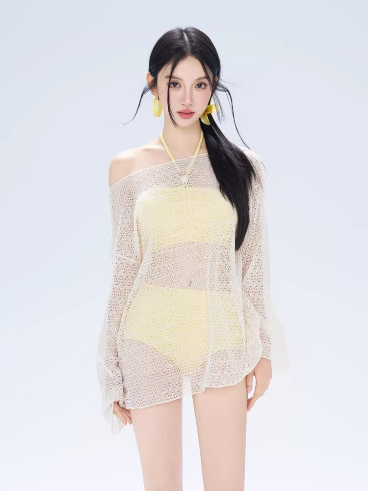 Model wearing a white open knit off-the-shoulder cover-up over a yellow halter bikini set.