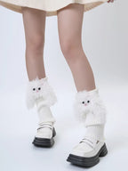 Person wearing white fuzzy character leg warmers and white loafers