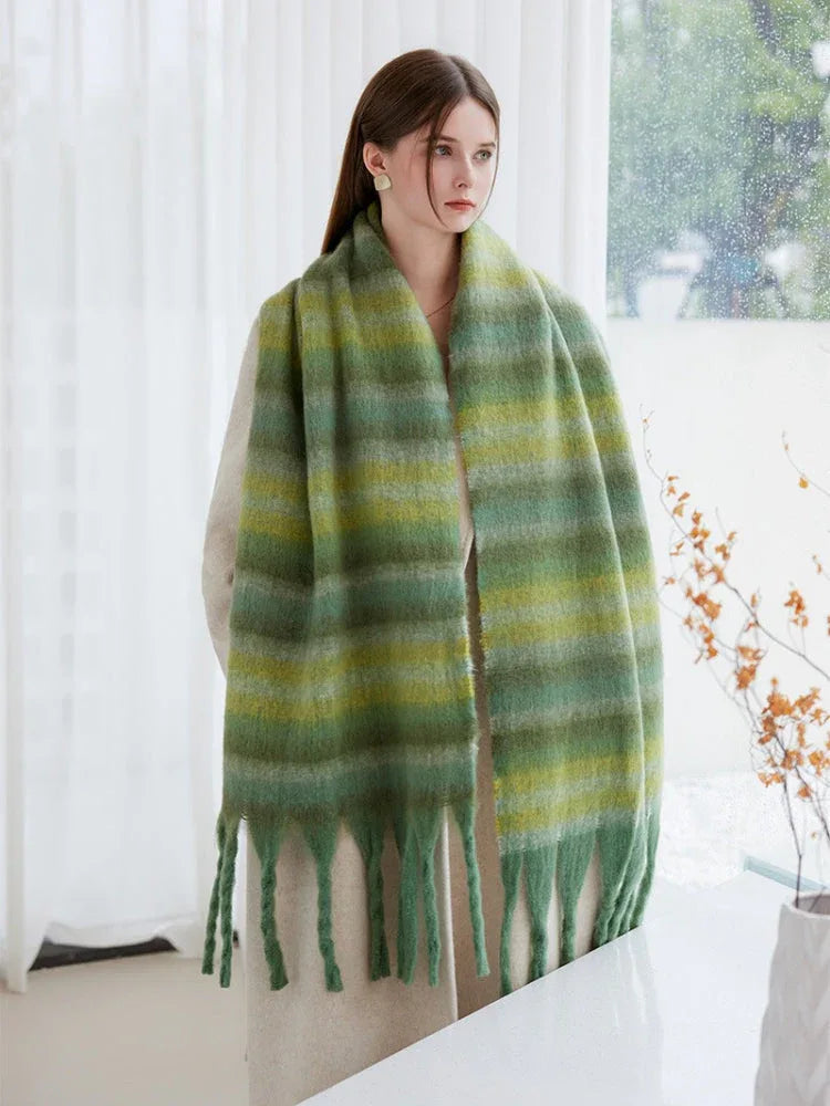 A woman accessorized with a vibrant green gradient striped scarf