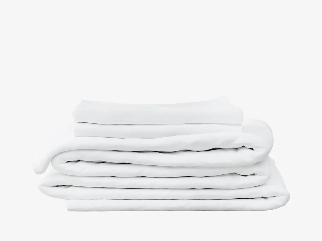 A stack of white folded bedding