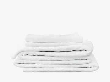 A stack of white folded bedding