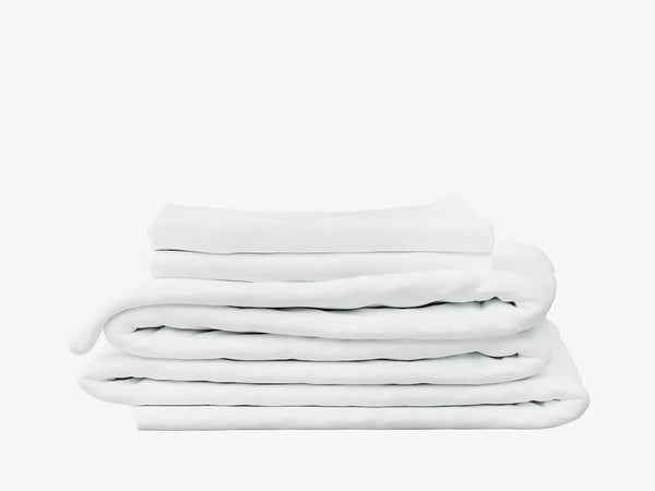 A stack of white folded bedding