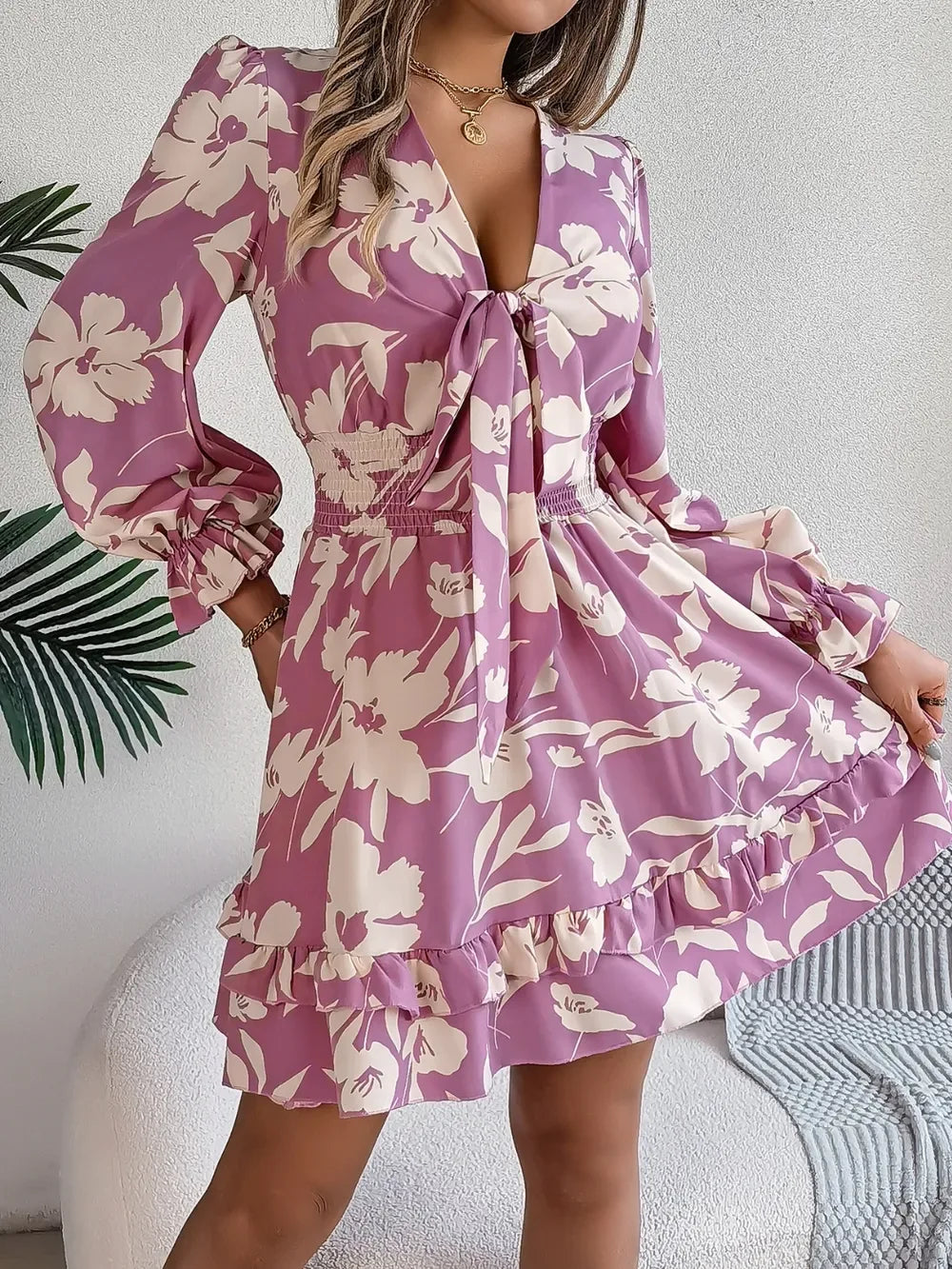 Close-up of the tie-front detail on a floral mini dress