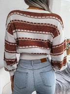 Back view of a woman in a white and brown striped knit sweater with a crew neck and long sleeves, paired with light wash denim jeans.