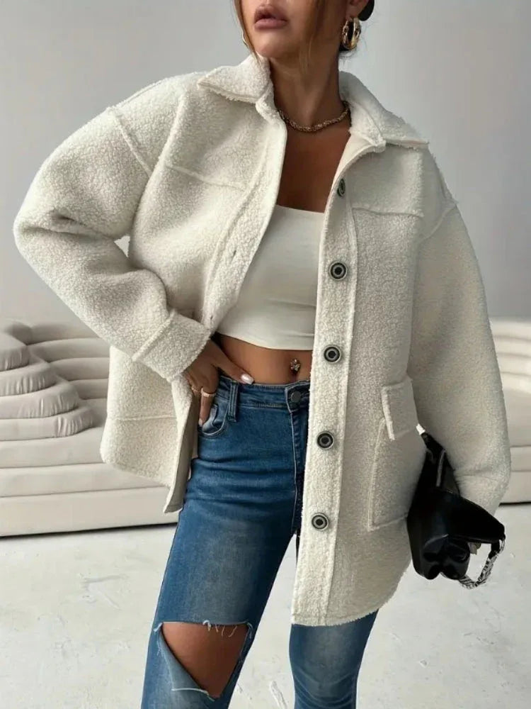 Woman wearing a cream-colored oversized fleece jacket with button-front closure and chest pockets. Main image