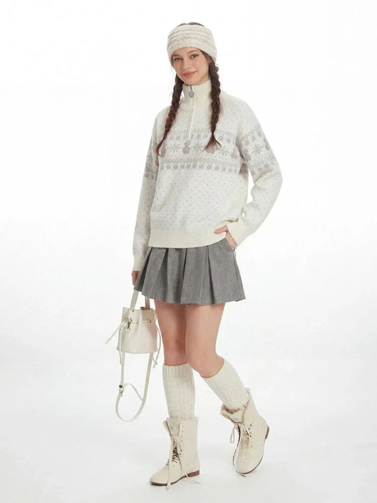 Front view of a woman in a cream-colored Fair Isle knit sweater with a half-zip neckline.