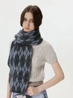 Woman with a gray and black argyle knit scarf draped around her neck