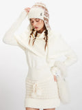 Woman posing in a cream knit turtleneck sweater with puffed sleeves and a cream knit mini skirt with a drawstring waist.