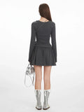 Back view of a dark grey ribbed drop waist mini dress, showcasing the silhouette.