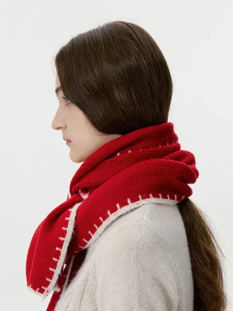 Red scarf with white trim, wrapped around the neck