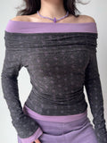 Front view of a woman modeling a grey and purple ruched off-the-shoulder top.