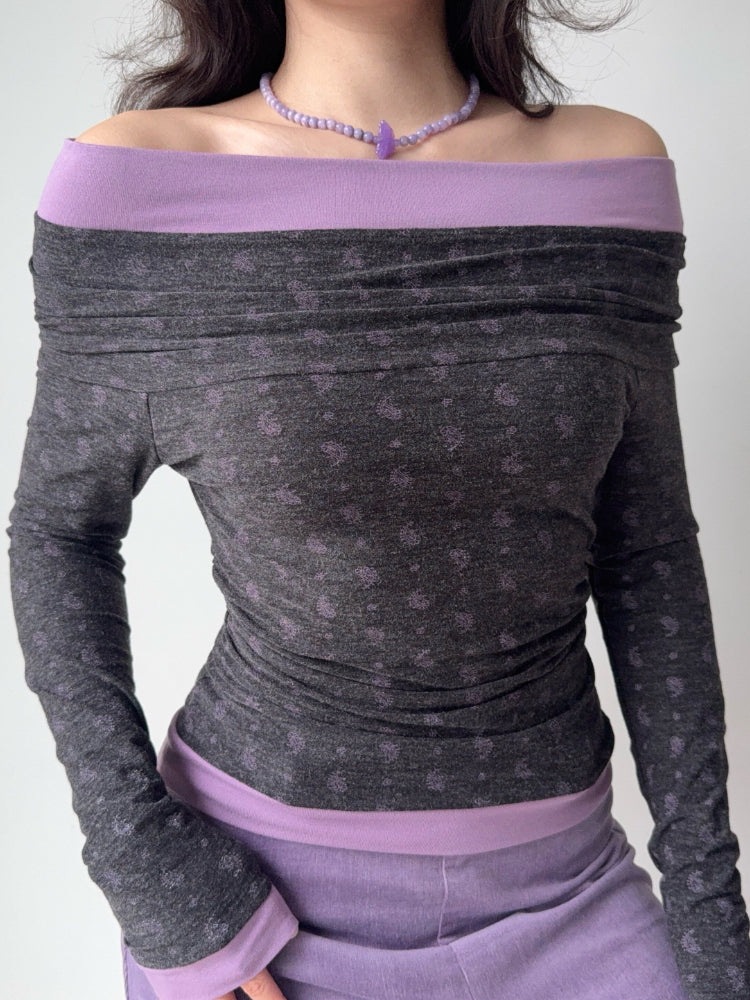 Front view of a woman modeling a grey and purple ruched off-the-shoulder top.