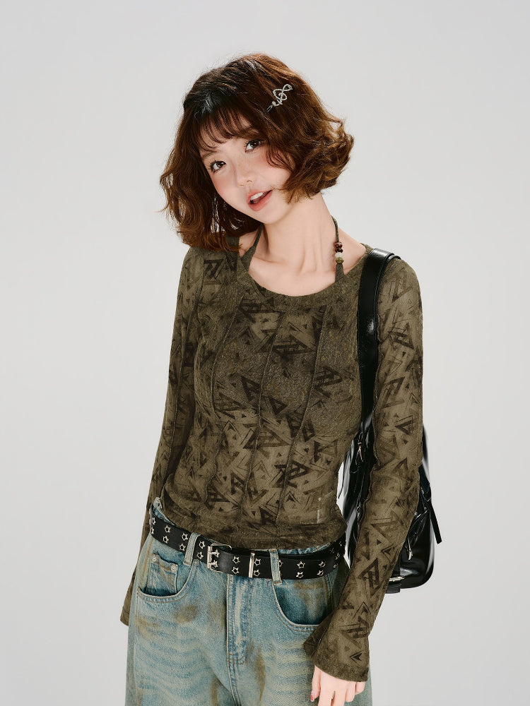Close-up of a woman's face and shoulders, wearing a long-sleeve olive green mesh top with a geometric print.