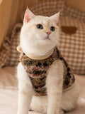 Cat wearing a multicolored fleece vest with a camouflage-like pattern