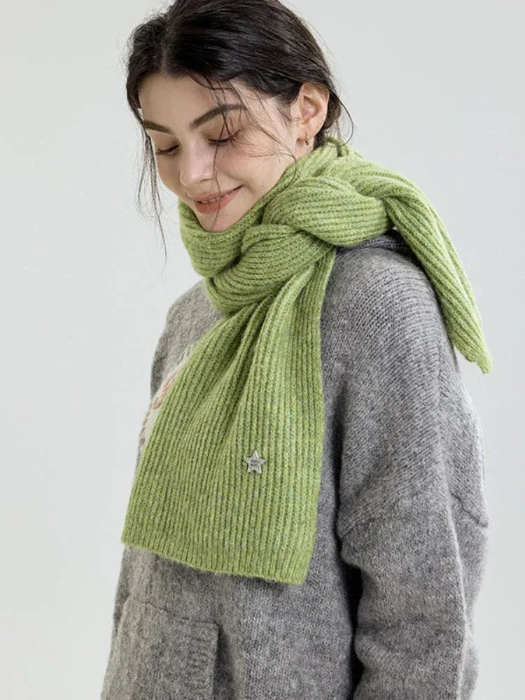 Side profile of a woman wearing a light green ribbed knit scarf.